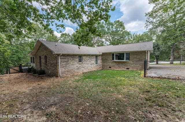 rear view of property with a yard