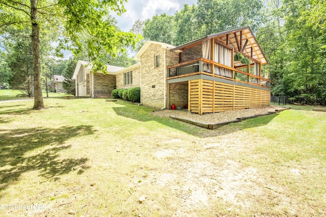 back of property with a wooden deck and a yard