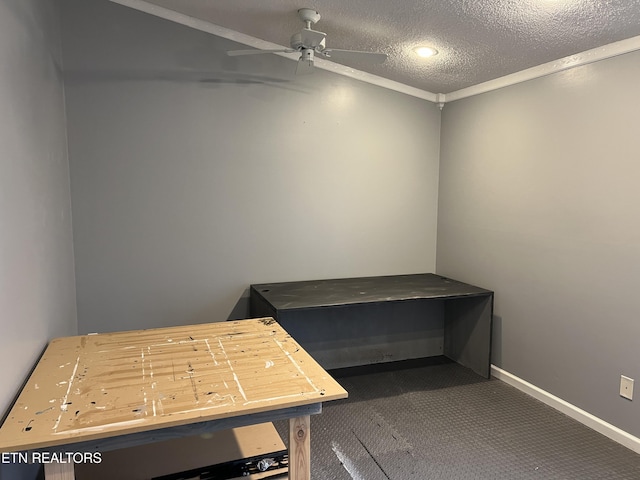 miscellaneous room featuring ceiling fan, a textured ceiling, ornamental molding, and carpet flooring