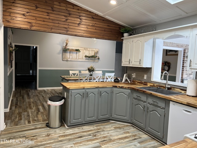 kitchen with gray cabinets, sink, white dishwasher, white cabinetry, and butcher block counters