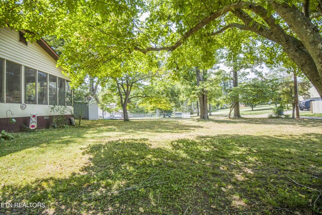 view of yard featuring a sunroom