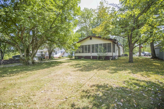 view of yard featuring a sunroom