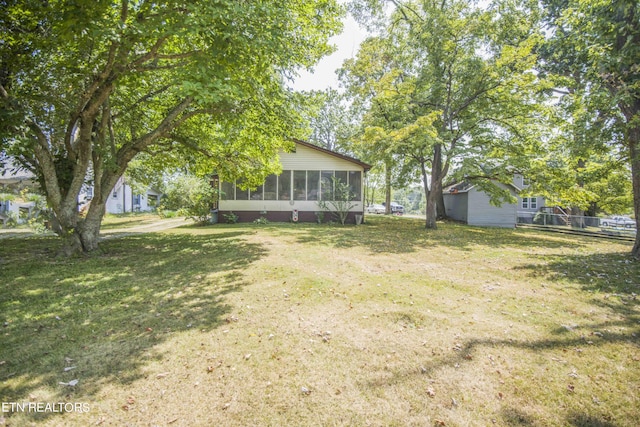 view of yard with a sunroom