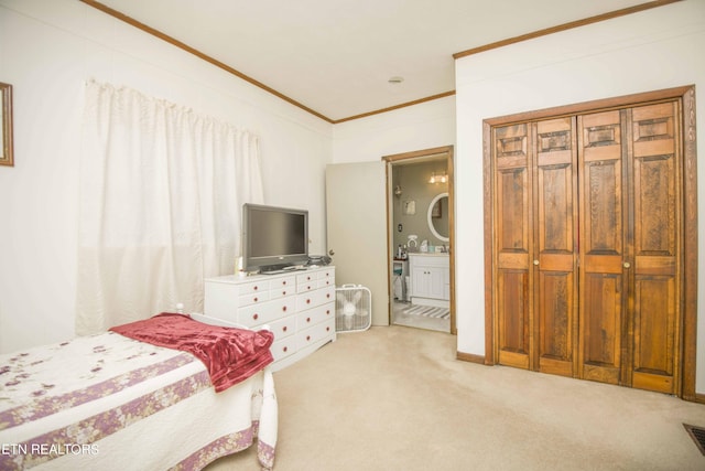 bedroom featuring visible vents, baseboards, ensuite bath, crown molding, and carpet flooring