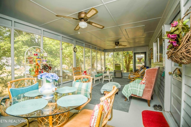 sunroom / solarium featuring ceiling fan