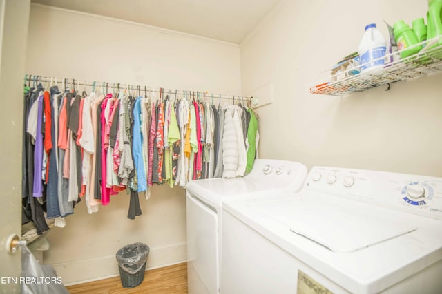 laundry area featuring laundry area, wood finished floors, and independent washer and dryer