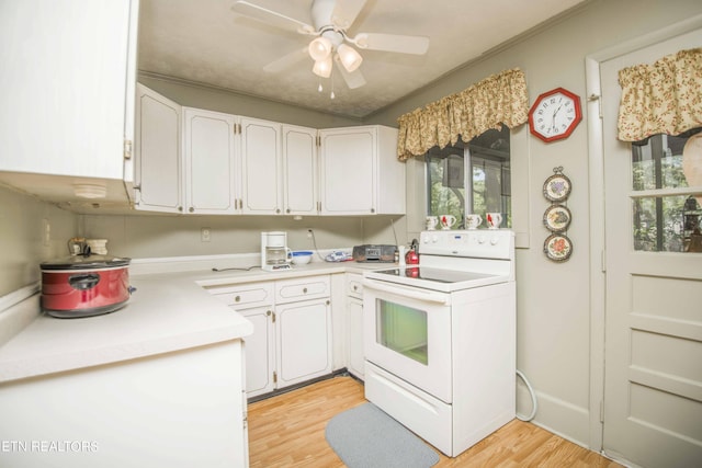 kitchen featuring light wood finished floors, white range with electric cooktop, and white cabinets