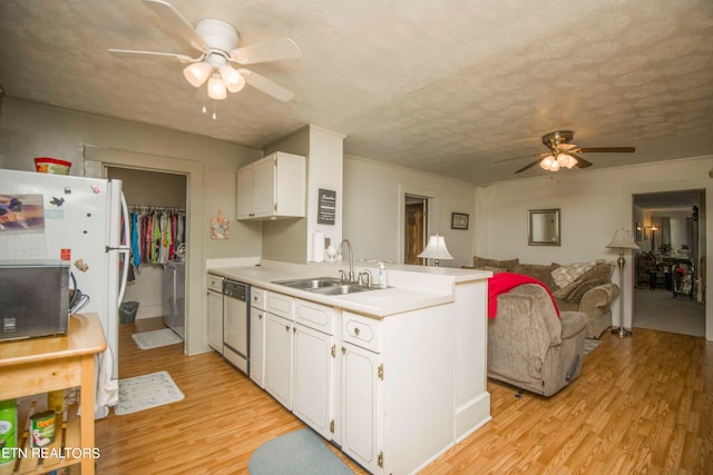 kitchen featuring sink, ceiling fan, stainless steel dishwasher, white cabinets, and light hardwood / wood-style floors