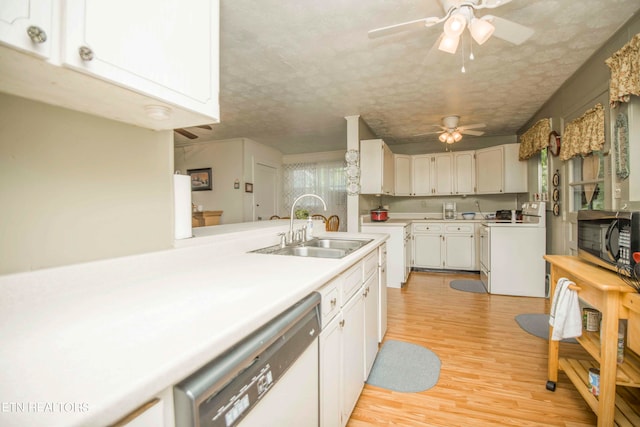 kitchen featuring light hardwood / wood-style flooring, white appliances, sink, ceiling fan, and a textured ceiling