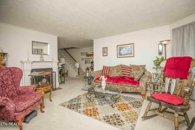 carpeted living room featuring a fireplace with flush hearth, a textured ceiling, and stairs