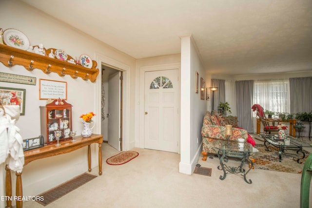 view of carpeted foyer entrance