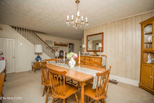 dining space with a chandelier and light colored carpet