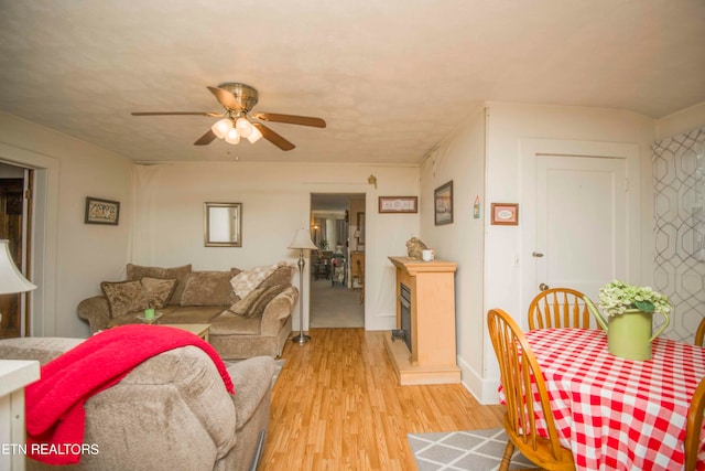 living room with ceiling fan and light hardwood / wood-style floors