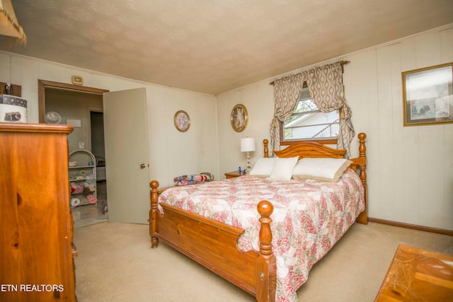 bedroom featuring carpet flooring and a textured ceiling