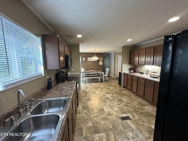 kitchen with dark countertops, visible vents, a sink, gas range, and black microwave