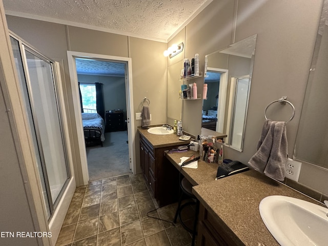 bathroom featuring a stall shower, a sink, a textured ceiling, and ensuite bath