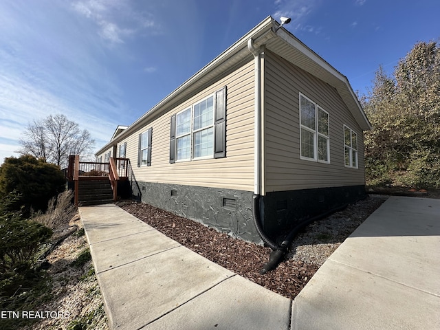 view of property exterior featuring a deck, stairway, and crawl space