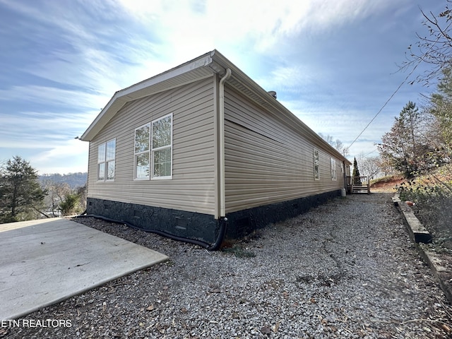 view of home's exterior with crawl space and a patio