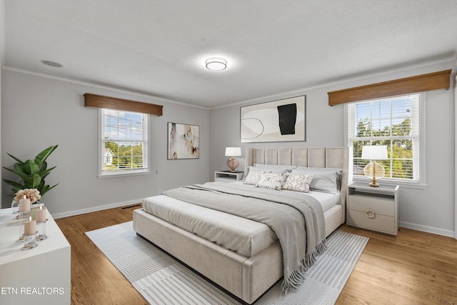 bedroom featuring hardwood / wood-style flooring and crown molding