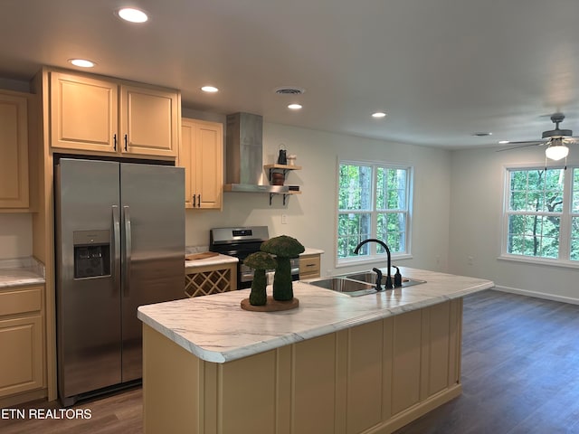 kitchen with dark hardwood / wood-style flooring, stainless steel appliances, a kitchen island with sink, sink, and wall chimney range hood