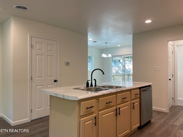 kitchen with dark wood-type flooring, a center island with sink, sink, stainless steel dishwasher, and decorative light fixtures