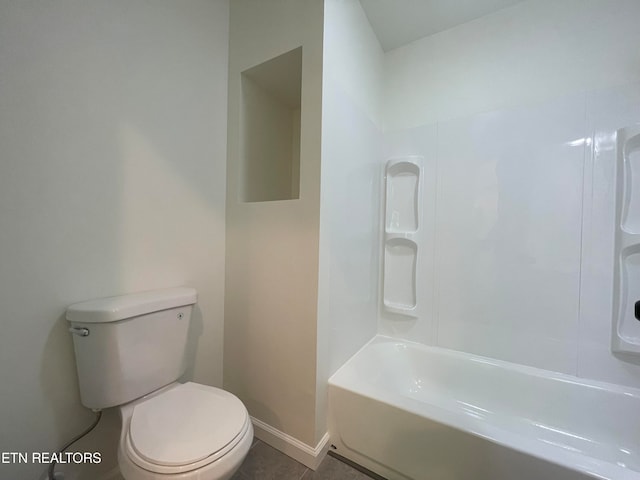 bathroom featuring tile patterned flooring, toilet, and shower / bath combination