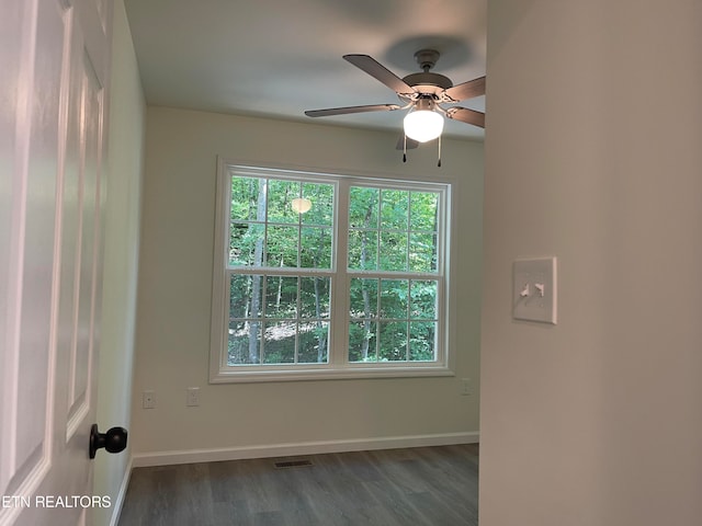 empty room featuring ceiling fan and dark hardwood / wood-style floors