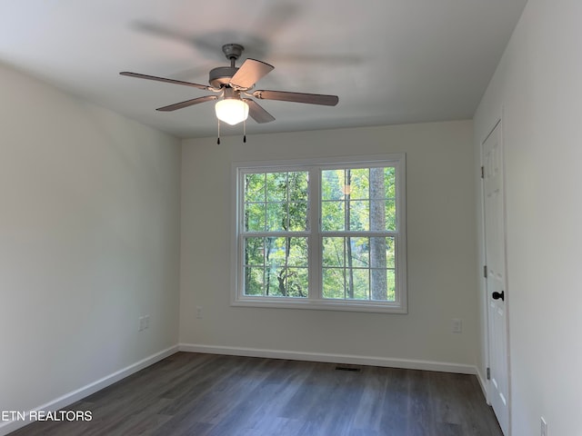 unfurnished room featuring ceiling fan and dark wood-type flooring