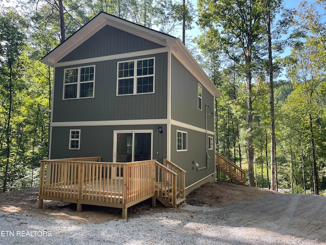 rear view of property featuring a wooden deck