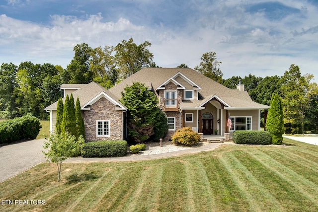 craftsman-style home with a front lawn