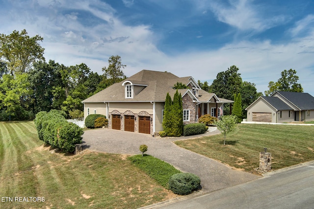 view of front facade with a garage and a front lawn