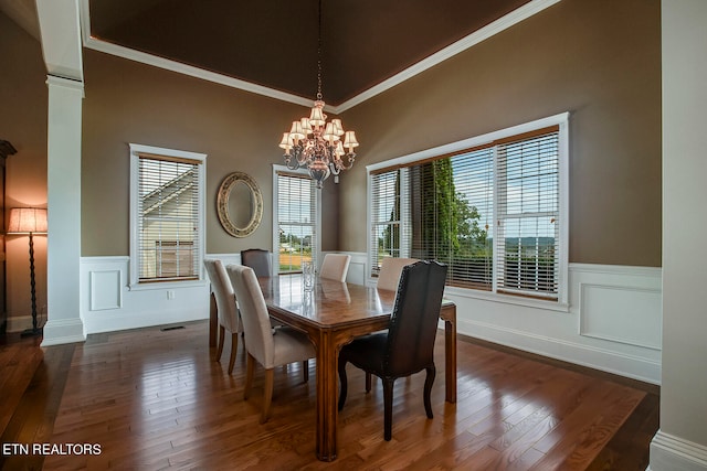 dining space featuring ornamental molding, dark hardwood / wood-style flooring, and a notable chandelier