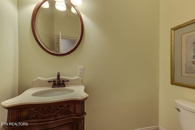 bathroom with toilet and vanity