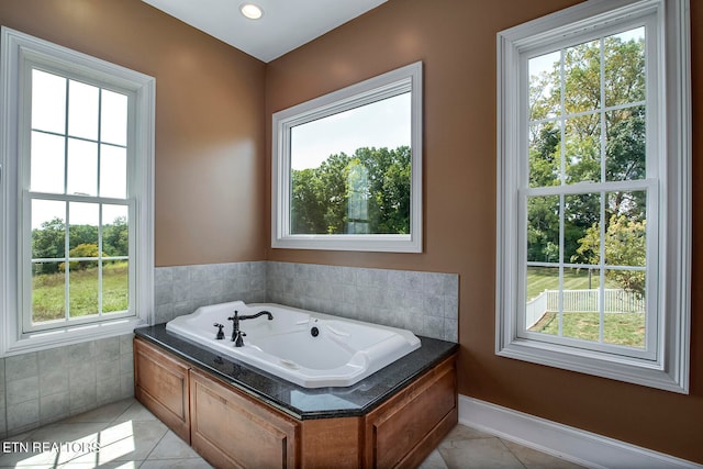 bathroom featuring plenty of natural light, a tub, and tile patterned flooring