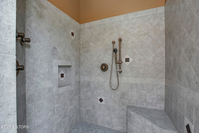 bathroom with tiled shower