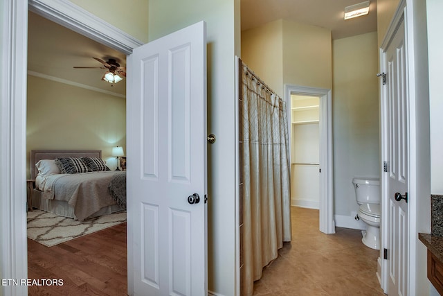 bathroom featuring ornamental molding, toilet, hardwood / wood-style flooring, and ceiling fan