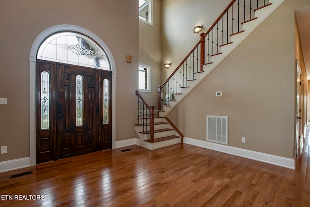 entrance foyer featuring a high ceiling and hardwood / wood-style floors