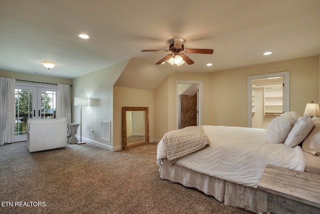 bedroom featuring ceiling fan, a walk in closet, a closet, and carpet floors