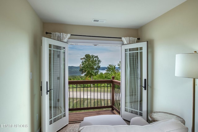 carpeted bedroom with french doors