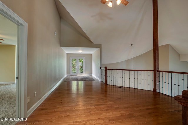 hall featuring high vaulted ceiling and light hardwood / wood-style floors