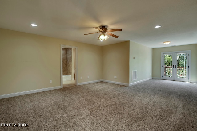 carpeted empty room with french doors and ceiling fan