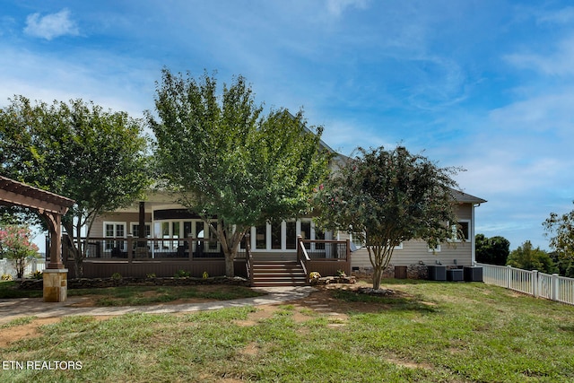 obstructed view of property with a deck, a front lawn, and central AC