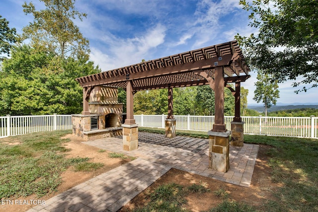 view of community featuring a pergola, a lawn, and a patio