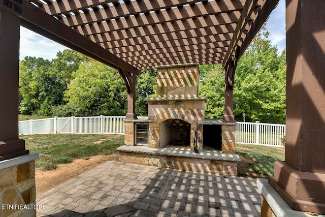 view of patio / terrace with an outdoor stone fireplace and a pergola