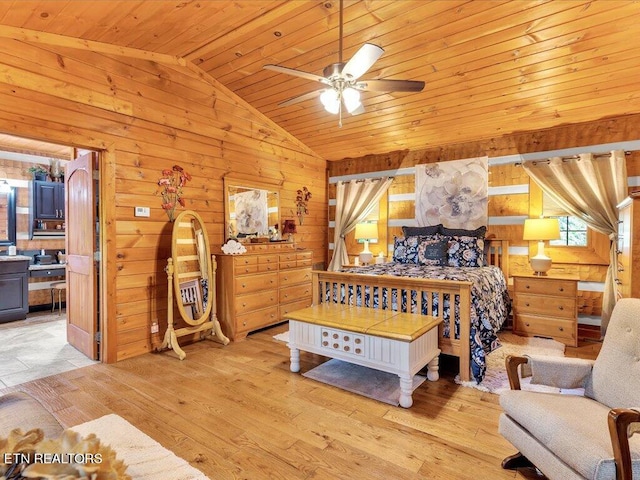 bedroom with wood ceiling, wooden walls, light hardwood / wood-style floors, and vaulted ceiling