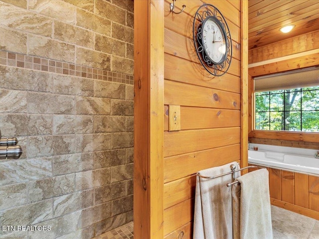 bathroom with separate shower and tub and tile patterned flooring