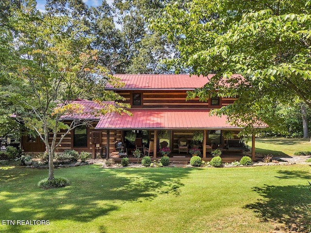 back of house featuring a lawn and covered porch