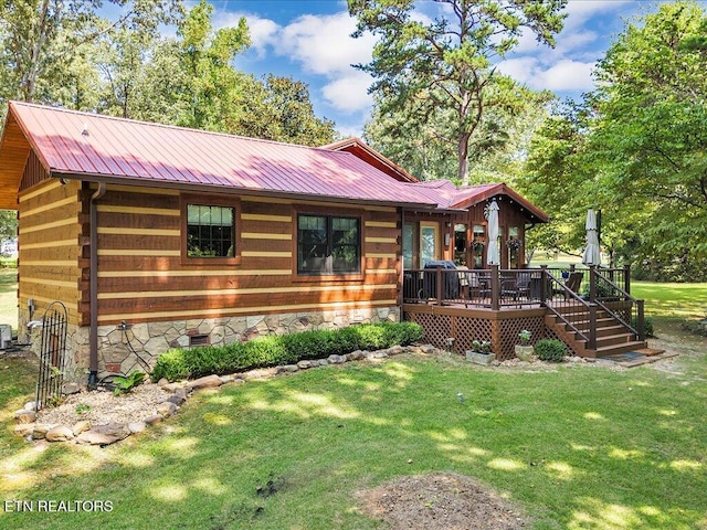 view of front of property with a wooden deck and a front yard