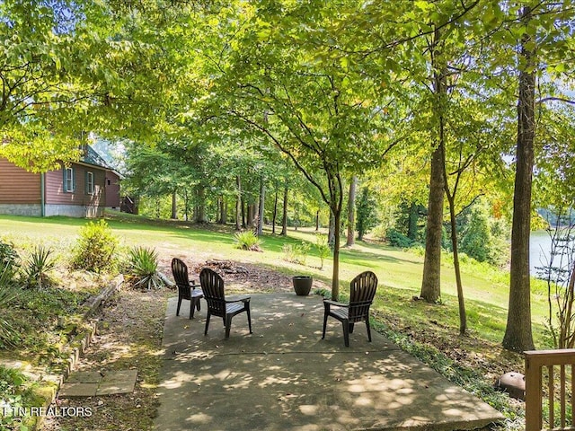 surrounding community with a lawn and a patio