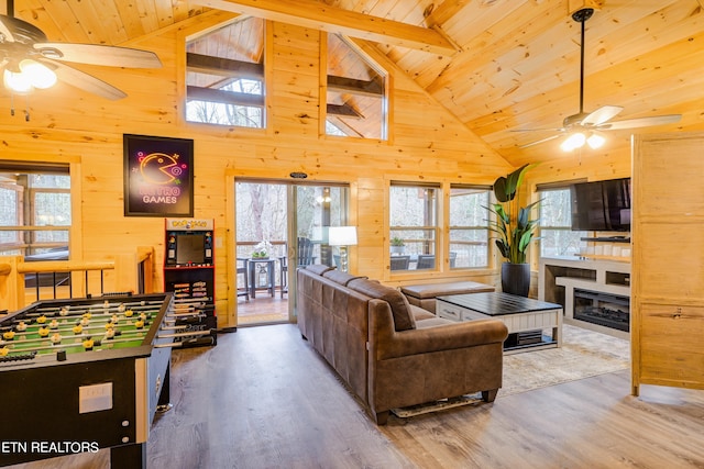 living room with high vaulted ceiling, ceiling fan, hardwood / wood-style flooring, and plenty of natural light